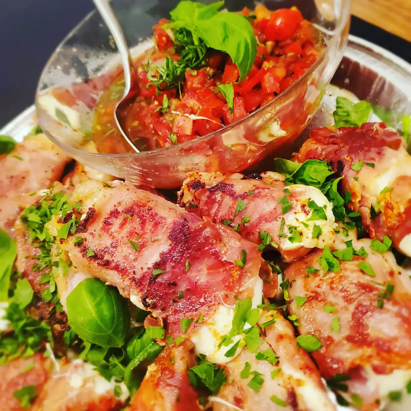 Herb-finished appetizer board with tomato relish prepared by Dragonfly Catering