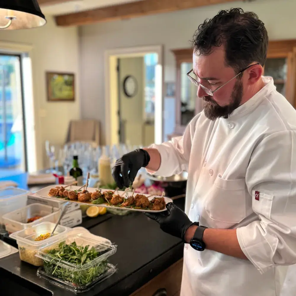 Chef Matt Stone finishing a tray of appetizers during a private Dragonfly Catering event