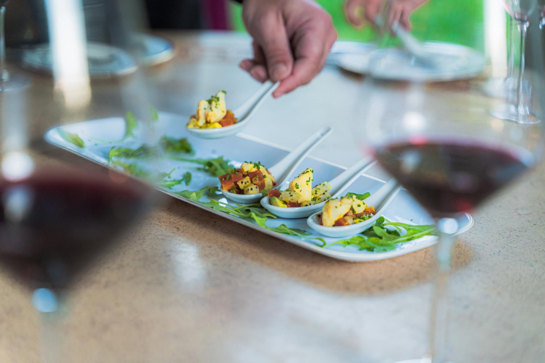Passed appetizers being arranged for guests at a Dragonfly Catering event