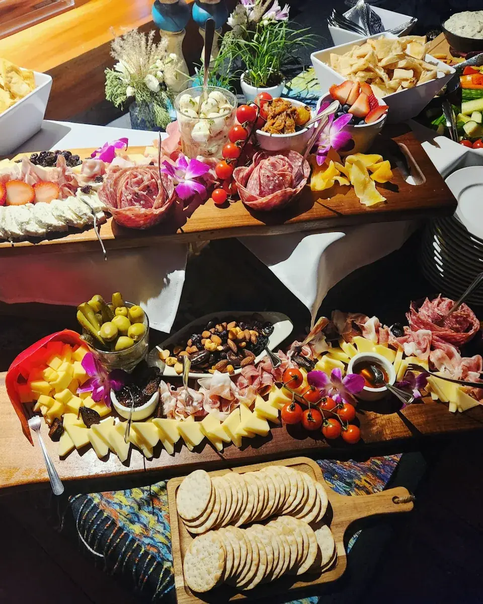 Charcuterie and cheese grazing table arranged by Dragonfly Catering