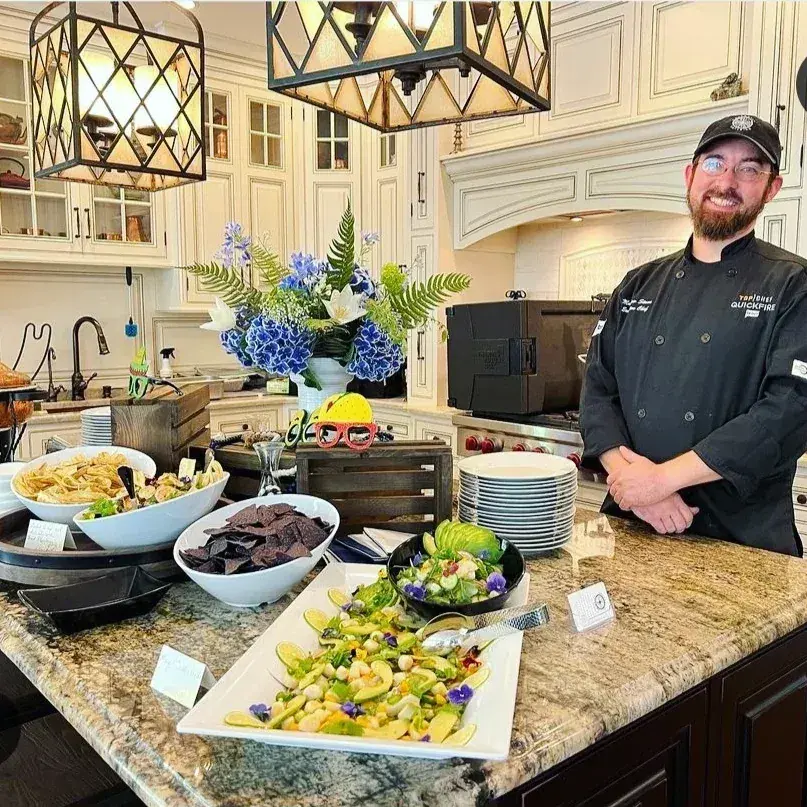 Chef Matt serving guests from a Dragonfly Catering buffet