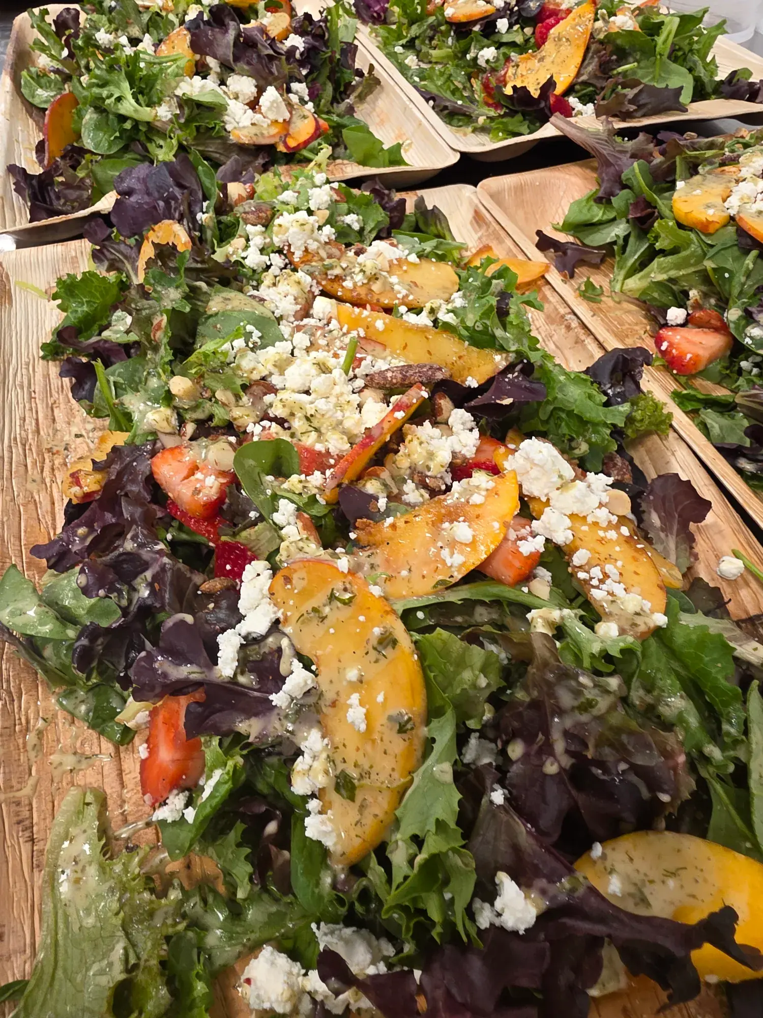 Seasonal peach and berry salad prepared by Dragonfly Catering