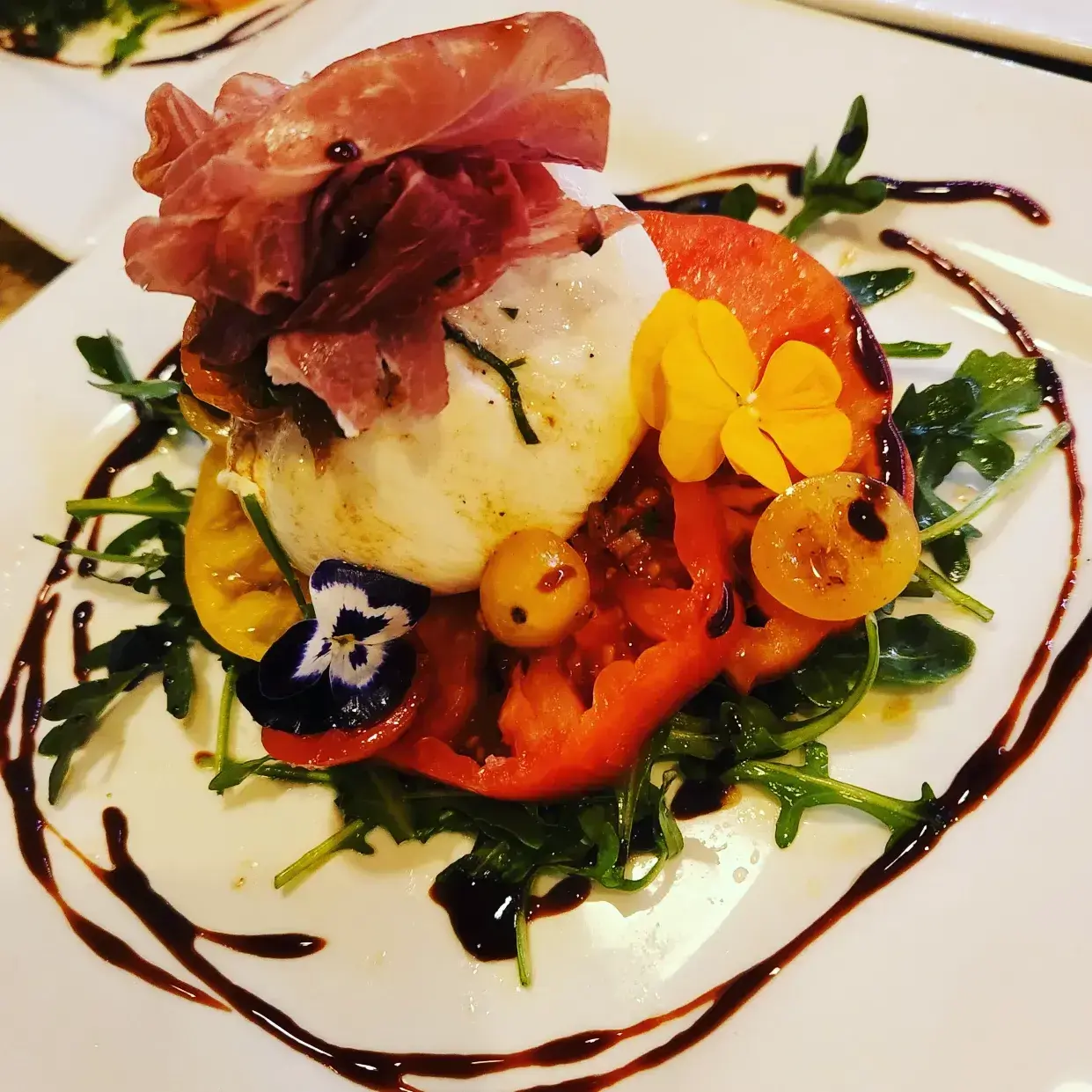 A colorful seasonal vegetable appetizer plated by Dragonfly Catering