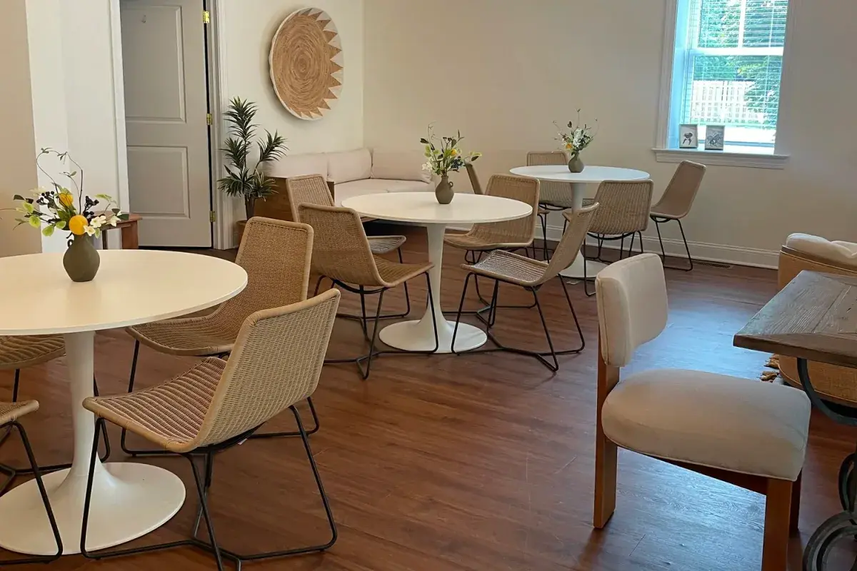 The warm modern interior and cafe tables at Bask Collective