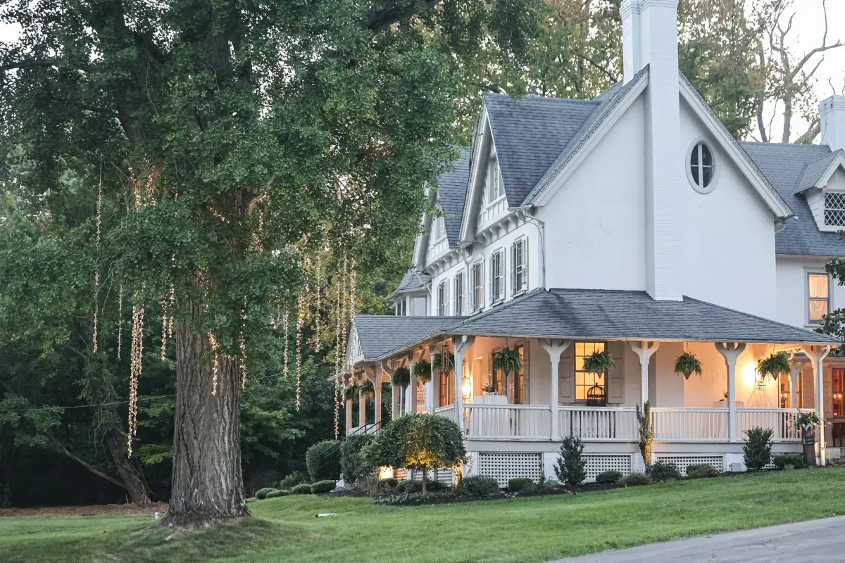 Cross Gables Estate glowing at dusk among mature trees