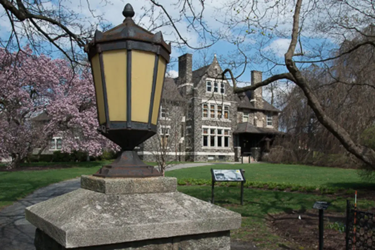 Historic Graystone Mansion framed by flowering trees