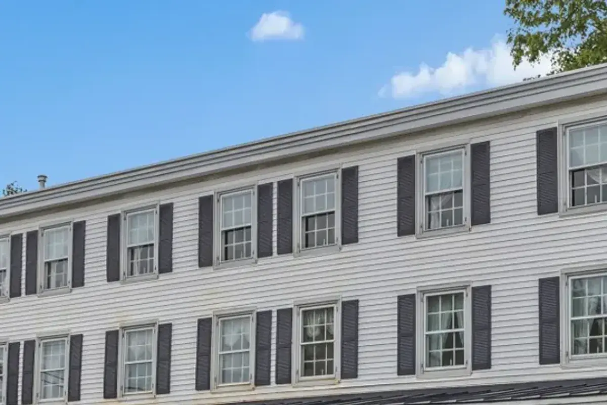 The white clapboard facade of the Inn at Twin Linden